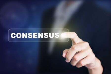 Businessman pressing a CONSENSUS concept button. Can be used in advertising.の写真素材