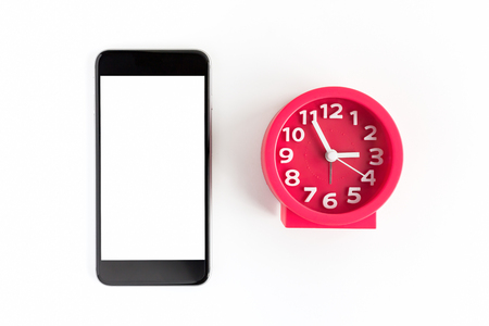 Alarm clock and smart phone on white backgroundの写真素材