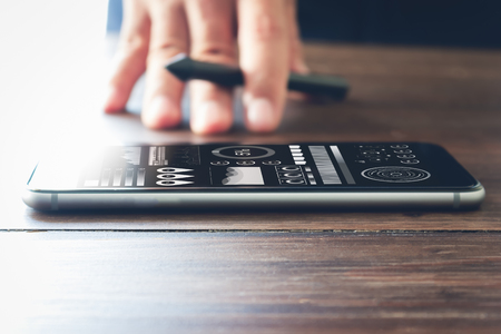 smartphone on desk, concept working through the phone online. vintage style, can be used for ad.の写真素材