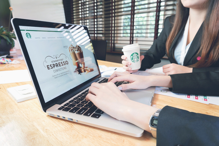 BANGKOK ,THAILAND - March 05, 2017 : Apple Macbook opening online page of Starbucks application, on the office room.のeditorial素材