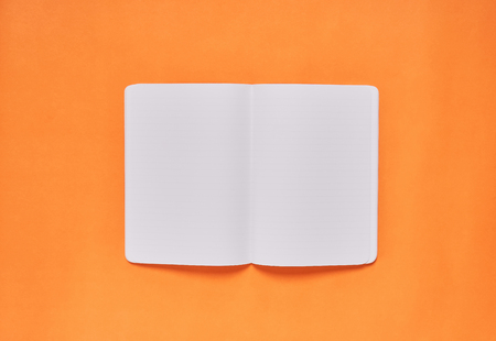 Blank white template open page is empty on orange background. Used to bring the template of the document used in advertising.の写真素材