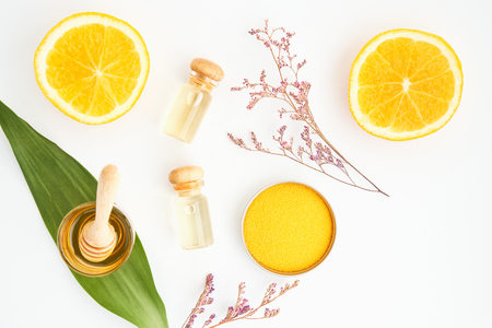 Top view, Bottle of natural oil and orange placed, Blank label package for mockup on white background and flowers. The concept of natural beauty products.の写真素材