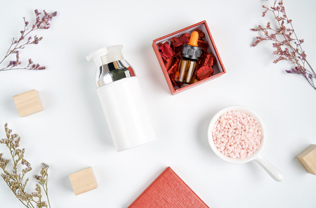 bottle placed, Blank label package for mock up on white background and flowers. The concept of natural beauty products.の写真素材