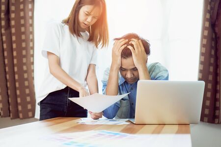 Young women are scolding employees who work late at work, Causing damage. The concept of punctuality makes it professional.の写真素材