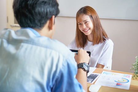 The staff is consulting with customers who use their business services.の写真素材