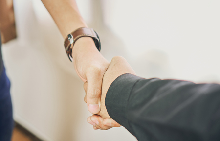Businessmen are shaking hands after successful negotiations in business, The concept of business advancement through collaboration.の写真素材