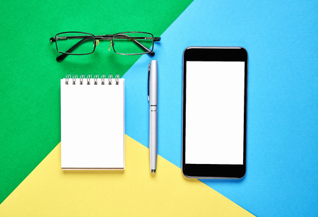 Top view, Modern workplace with book with smart phone placed on a pastel  background. Copy space suitable for use in graphics.の写真素材