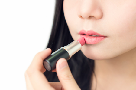 Close up of woman applying red lipstick with brush on mouth skin beauty and health, for spa products and make up. The skin is smooth and beautiful. concept of healthy women.の写真素材