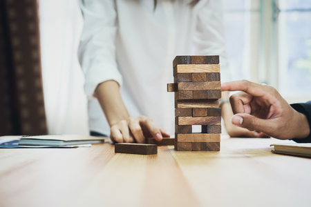 women and teamwork making a pyramid with empty wooden cubes. Business concept with step-by-step for a firm basis.の写真素材