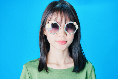 Women wear fashion glasses Showing happy gestures, Blue background.の写真素材