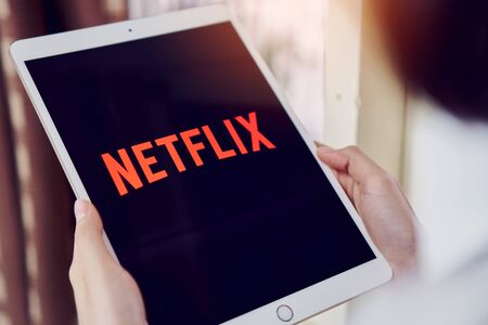 Bangkok, Thailand - January 16, 2018 : Netflix app on tablet screen. Netflix is an international...