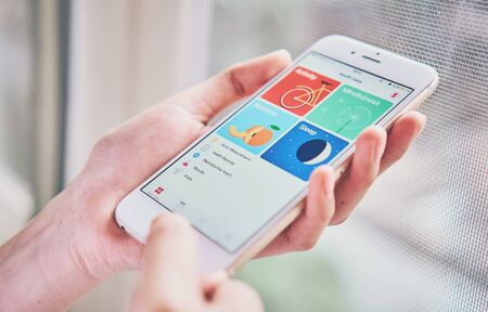 BANGKOK ,THAILAND - January 9, 2018 : women holding smartphone on the Health app screen on iPhone 6. is an application for iOS 11 which monitor the fitness data of the user.のeditorial素材