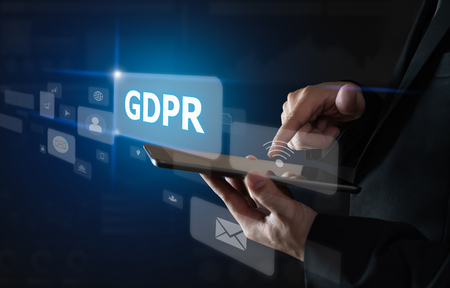 Businessman holding tablet and sign text GDPR (Data Protection Regulation). Cyber security.の写真素材