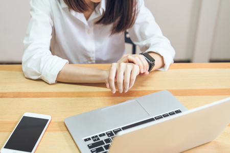 Women have a pain in the wrist because of the computer for a long time. This may be the cause of Office Syndrome.の写真素材