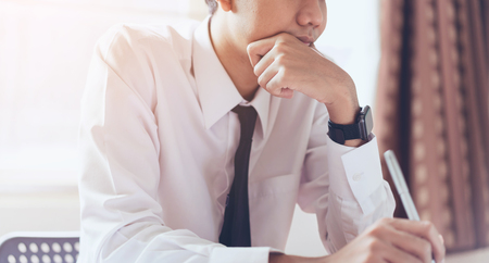 Businessman working at his office with documents.の写真素材