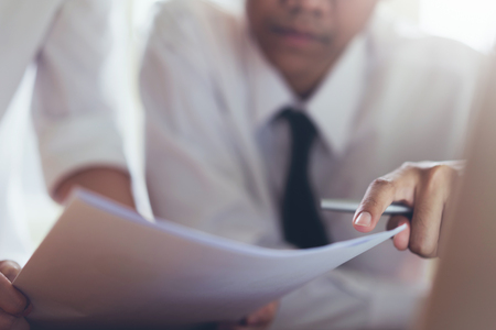 Businessman working at his office with documents and check the accuracy of information.の写真素材