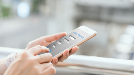 Woman holding smartphone to enter online payment from the store. Concept of providing marketing services on the internet for easy access to information.の写真素材