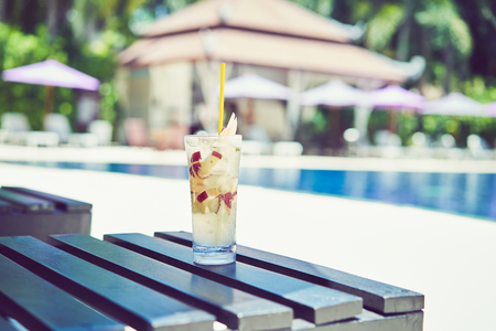 A glass of water juice on swimming pool in vacation and summer time.の写真素材
