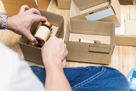 Employees are packing a parcel in the send to the customer. Online ordering For the convenience of...