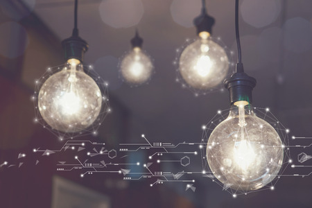 Light bulb hanging on the ceiling of the cafe. map network connection, concept social media diagram of growth. vintage toneの写真素材