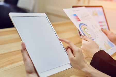 Woman using blank screen tablet. Blank screen for the graphics. Concepts for Digital Technology in...
