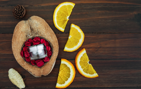 White vitamin c bottle and oil made from orange fruit extract, mockup of beauty product brand. Top view on the wood background.の写真素材