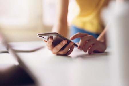 Woman using smartphone. The concept of using the phone is essential in everyday life.の写真素材