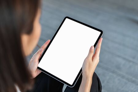 Mock up of female hand holding digital tablet blank screen on isolated. Take your screen to put on advertising.の写真素材