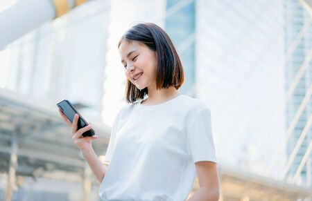 Asian women of happy smiling and using smartphone.The concept of using the phone is essential in everyday life.の写真素材