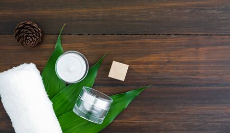 Cream bottle set and serum, mockup of beauty product brand. Top view on the wood background.の写真素材
