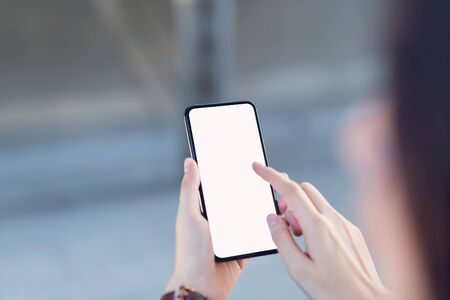 Hand holding smartphone blank screen on isolated. Take your screen to put on advertising.の写真素材