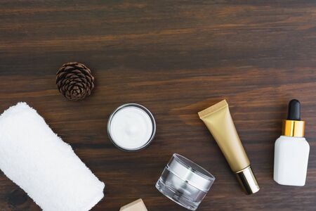 Cream bottle set and serum, mockup of beauty product brand. Top view on the wood background.の写真素材