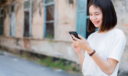 Asian women of happy smiling and using smartphone.The concept of using the phone is essential in everyday life.の写真素材