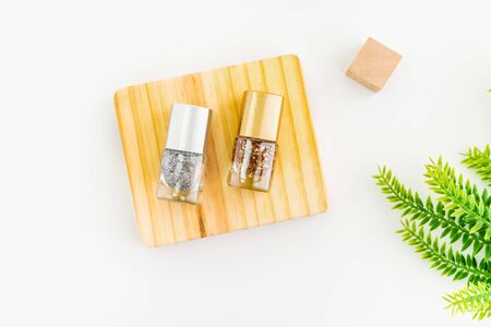 Nail polish of beautiful colorful on wood platform and white background.の写真素材