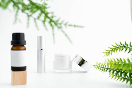 White serum bottle and cream jar, mockup of beauty product brand. Top view on the white background.の写真素材