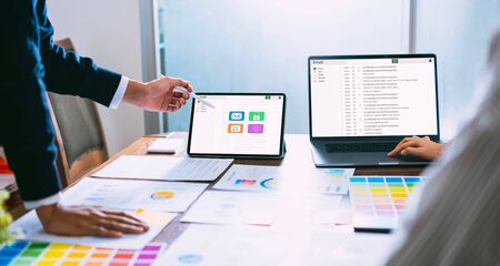 Businessman using laptop and tablet reading email screen connection communication. concept of working online system.の写真素材