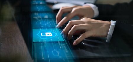 Technology concept with cyber security internet and networking, Businessman hand working on laptop, screen padlock icon on digital display.の写真素材