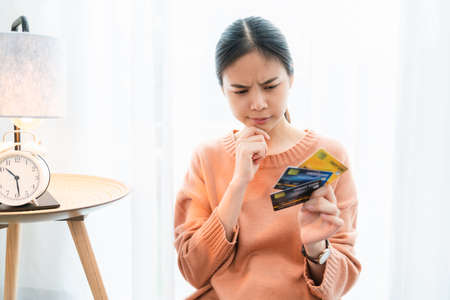 Shocked excited Asian woman holding credit card, Because a lot of expenses.