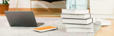 The education concept, Computers laptop, and books are placed on the carpet at home. proportion of the banner for ads.の写真素材