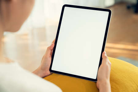Hand holding digital tablet mockup of blank screen. Take your screen to put on advertising.