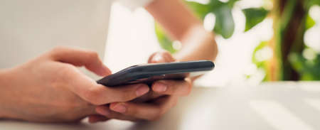 Stock exchange market concept, hand trader looking smartphone with graphs analysis candle line,...