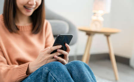 woman holding a smartphone and using online social on lifestyle. Technology for communication concept.の写真素材