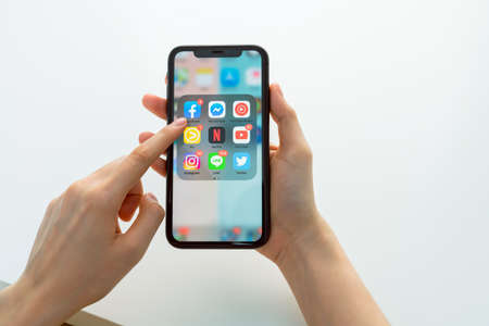 Bangkok, Thailand - September 5, 2020 : Facebook screen on apple iphone 11 and iPad on the table, Social media are using for information sharing and networking.のeditorial素材