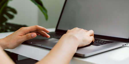 Hand using laptop blank screen on the table.の写真素材