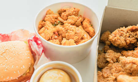 Fried chicken and burgers with rice, mashed potatoes on the table. Fast food, ready to eat easily.の写真素材