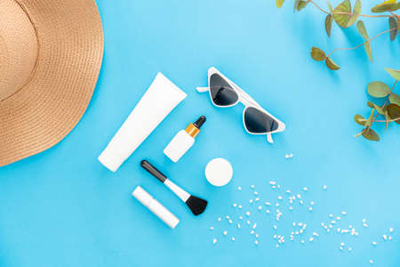 White bottle cream, mockup of beauty product brand. Top view on the blue background.