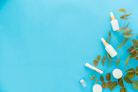 White bottle cream, mockup of beauty product brand. Top view on the blue background.の写真素材
