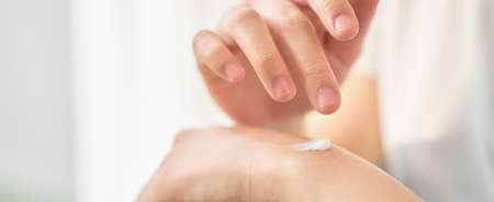 Close up of woman hand holding and applying moisturiser, Body lotion, isolated on white background.の写真素材