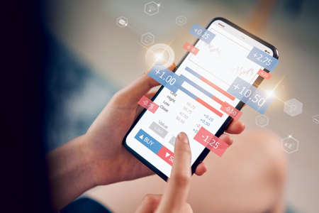 Stock exchange market concept, hand trader looking smartphone with graphs analysis candle line,...