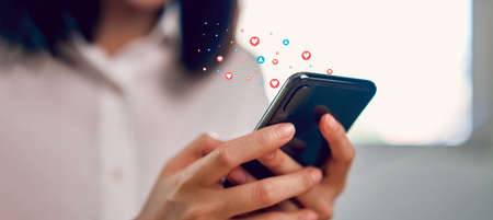 woman hand using smartphone and show heart icon social media. Concept social network.